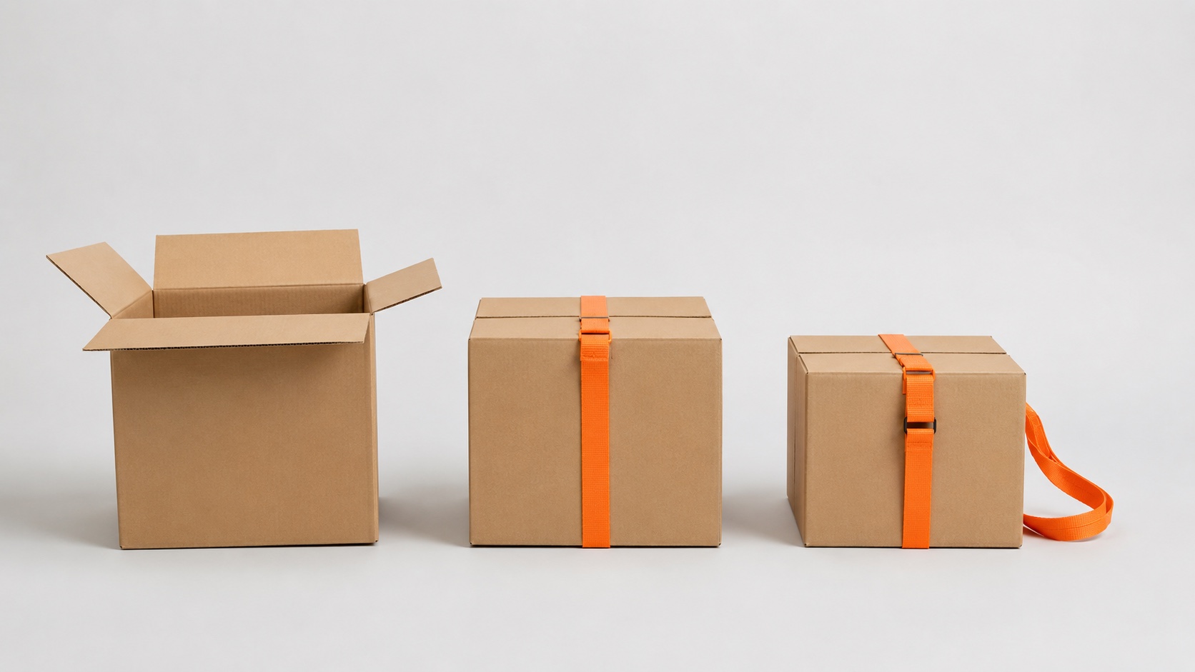 Three graded kraft moving boxes in a row on a clean background